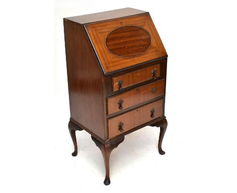 A 1920s mahogany bureau of slender proportions with panelled fall above four long drawers on cabriole legs, height 102cm, wid