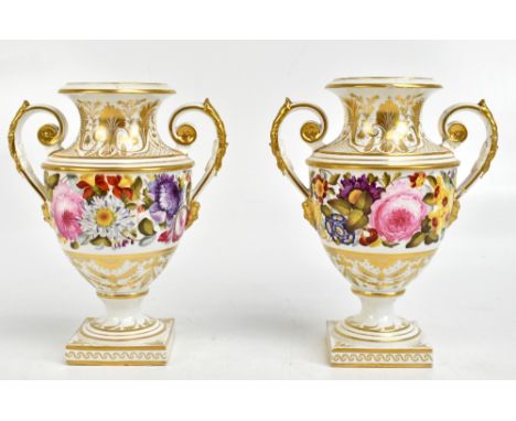 DERBY; a pair of 19th century handpainted twin handled pedestal vases, decorated with roses and floral sprays, painted marks 