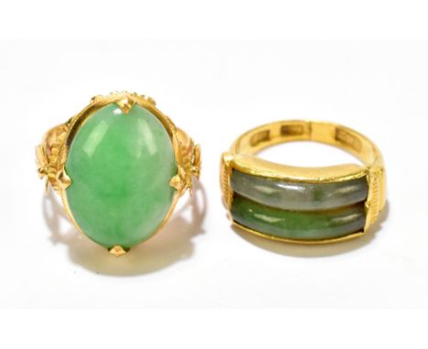 A Chinese yellow metal and polished oval jade cabochon four claw set ring size L and a further Chinese yellow metal and polis