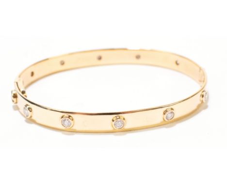 A yellow metal and diamond love bangle, set with ten diamonds, complete with locking screwdriver, stamped 750, approximate we
