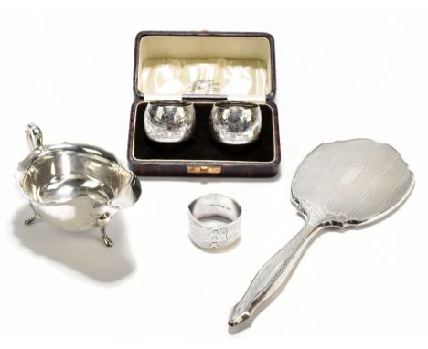 EMILE VINER; a George V hallmarked silver sauceboat raised on three pad feet, Sheffield 1936, length 14.4cm, a cased pair of 