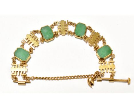 A Chinese yellow metal bracelet of open work design set with four jade coloured plaques of canted rectangular form, with scre