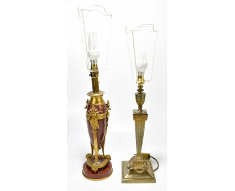 A mid-20th century rouge marble and gilt metal mounted table lamp, decorated with stylised shields and pipes, raised on hoof 