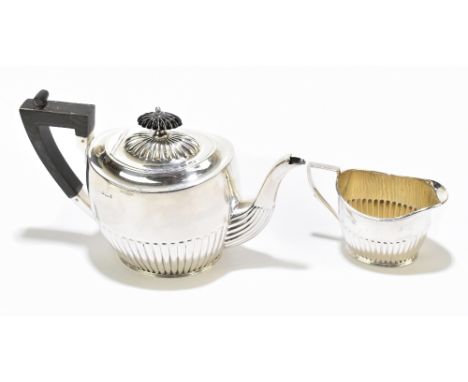 HENRY ATKIN; a late Victorian hallmarked silver bachelor's teapot and milk jug, Sheffield 1895, length of teapot 20.5cm, comb