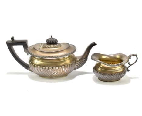 A &amp; J ZIMMERMAN; a Victorian hallmarked silver teapot with ebonised handle and gadrooned detail, Birmingham 1897, length 