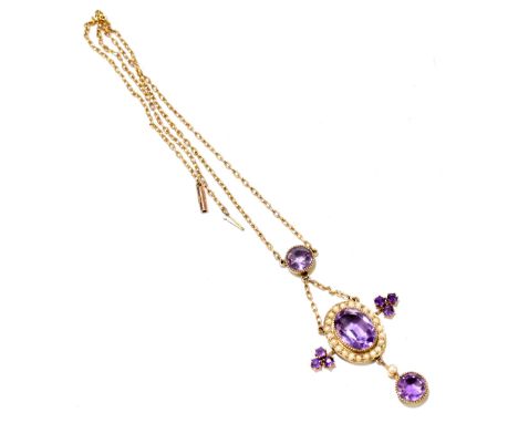 An Edwardian amethyst and seed pearl set yellow metal pendant and 9ct chain, with a circular amethyst above an oval amethyst 