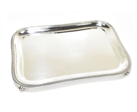 EDWARD BARNARD &amp; SONS LTD; a George V hallmarked silver tray of rounded rectangular form raised on four scrolling corner 