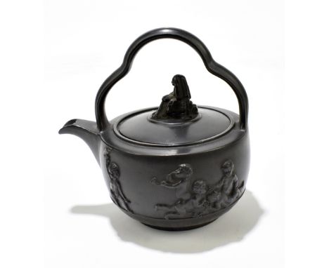 A late 18th century black basalt teapot and cover/rum kettle in the manner of Wedgwood and Bentley, the lid surmounted by a k