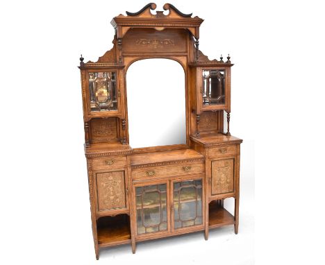 An Edwardian inlaid rosewood display cabinet, the raised back with an arched bevelled mirror flanked by two glazed doors over