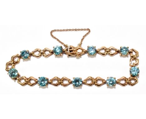 A 9ct yellow gold and synthetic pale blue stone set bracelet, length approx 19cm, approx 14.9g.Additional InformationSurface 