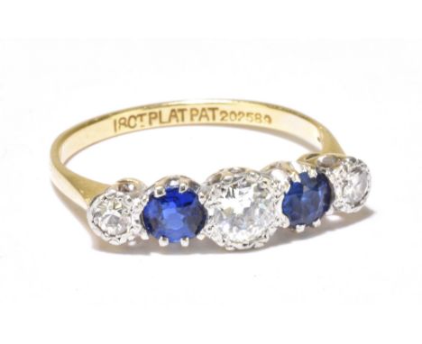 An 18ct yellow gold and platinum set diamond and sapphire ring, the central diamond weighing approx 0.33ct, size M/N, approx 