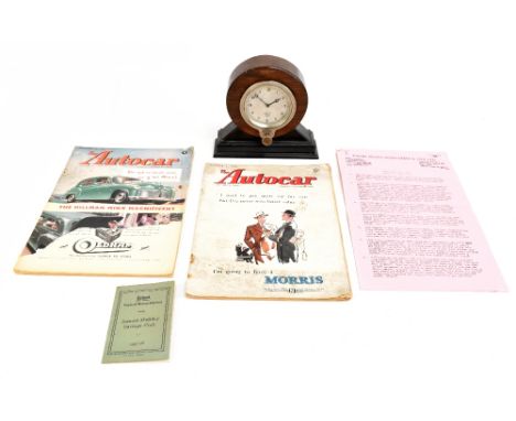 SMITHS; a chrome mounted car clock, later mounted in an oak case, the silvered dial with Arabic numerals, height 16.5cm, toge