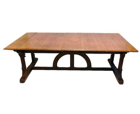 IN THE MANNER OF AUGUSTUS WELBY NORTHMORE PUGIN; an oak Gothic Revival dining table with moulded rectangular top above shaped