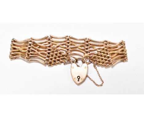 A 9ct yellow gold gate link bracelet with padlock clasp and textured&nbsp;decoration to the central bands, weight&nbsp;approx