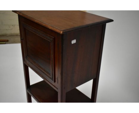 A mahogany smoker’s cabinet, the hinged door enclosing pipe rack and single shelf above under-tier, height 78cm, width 48cm, 