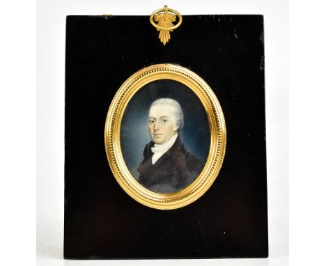19TH CENTURY; watercolour on ivory, portrait miniature, quarter length of a gentleman looking to his left, wearing a black co