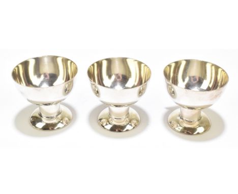 A set of three German 800 grade silver cups of plain form, stamped with stylised manufacturer's mark, height 5.5cm, approx 5.