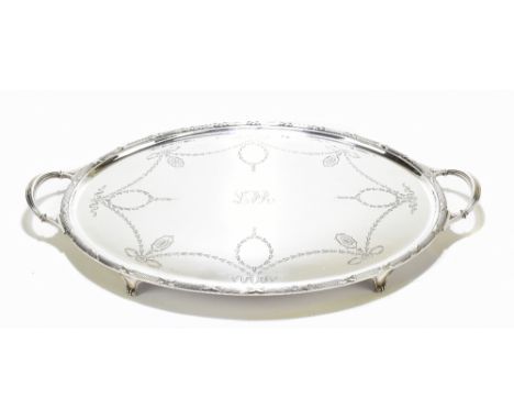 An Edwardian silver plated twin handled oval tray, with central overlaid initials 'LFR' within a border of harebell swags, le
