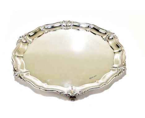 ATKIN BROS; a George V hallmarked silver salver raised on three scrolling supports, Sheffield 1924, diameter 32.5cm, approx. 