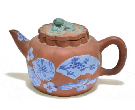 A 20th century Chinese earthenware Yixing teapot with slip decoration and moulded Dog of Fo finial, impressed seal mark to ba