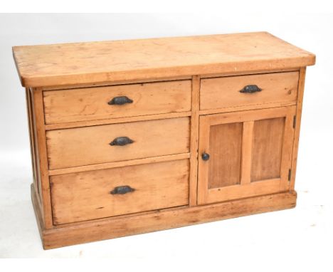 An old pine dresser base with arrangement of four drawers and a cupboard door enclosing single shelf, height 83cm, width 137c