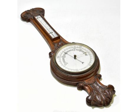 A late 19th/early 20th century carved oak barometer and thermometer, length 84cm.Additional InformationGlass is cracked, scuf