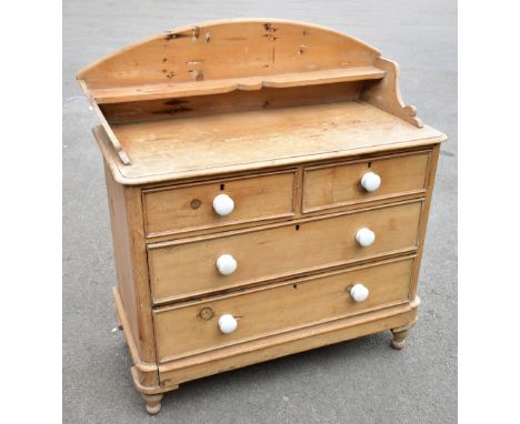 A Victorian pine chest of two short and two long drawers, with raised and arched back, on turned legs, height 120cm, width 11