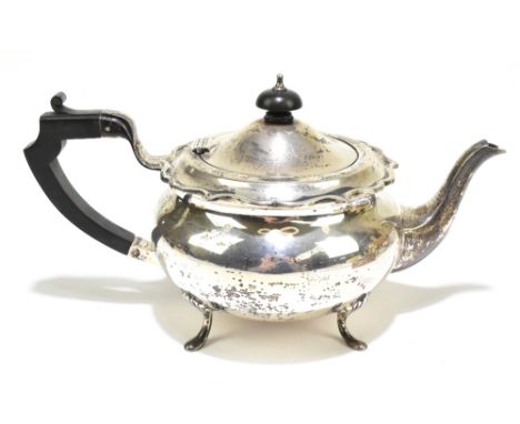 G BRYAN &amp; CO; a George V hallmarked silver teapot of bulbous form with cast scrolling rim, Birmingham 1933, approx weight