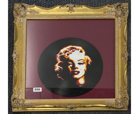 An unusual gilt framed portrait of Marylin Monroe painted on a vinyl record, 53 x 52cm.