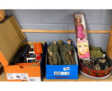 A group of Action Man figures and accessories with a group of other toys with a boxed Barbie doll.