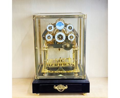 A contemporary four glass rolling ball mantle clock, H. 30 x 27 x 43cm.