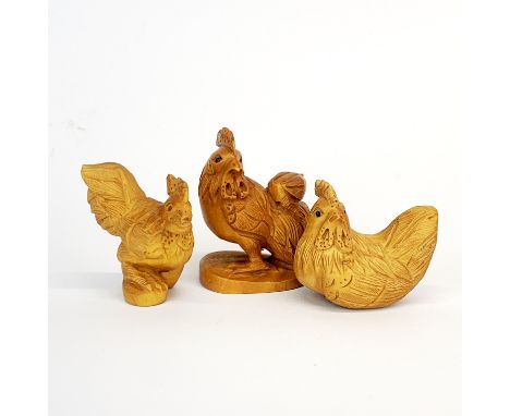 Two carved fruitwood netsuke of chickens and one further carving, tallest 5.5cm.