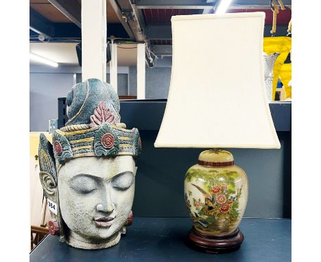 A painted composition Buddha head, H. 32cm. Together with an Oriental design table lamp.