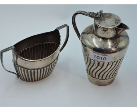 A small Victorian silver lidded jug having gadrooned decoration, Birmingham 1894, Stokes &amp; Ireland Ltd, and a silver suga