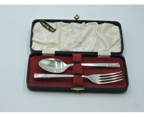 A cased child's silver first spoon and fork having moulded stems with plain cartouche, Sheffield 1963, Viners, approx 49.1g