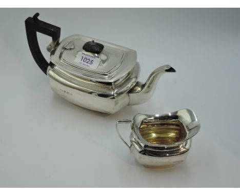 A silver breakfast teapot and cream jug of plain ovoid form with hard wood architectural handle, Birmingham/Chester 1915, Jos