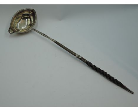 A Georgian silver toddy ladle having baleen twist handle with silver knop, London 1797, makers mark worn