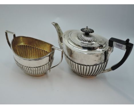 A silver teapot and sugar bowl having gadrooned decoration and architectural handles, Sheffield 1918, James Deakin &amp; Son,