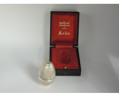 A Stuart Devlin limited edition silver gilt surprise egg (no: 46) having honeycomb style textured case opening to reveal an e