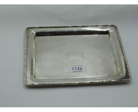 A Chinese silver dressing table tray of small rectangular form having rim modelled as bamboo and monogrammed cartouche, beari
