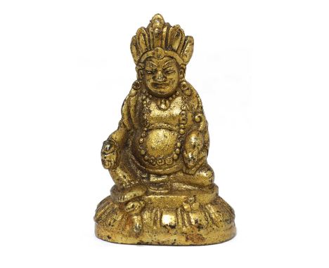 A Chinese miniature gilt-bronze bodhisattva, Vaisravana, seated on a lotus pedestal, his lower garment with a scroll border, 
