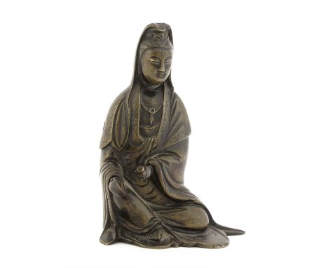 A Chinese bronze Guanyin,Qing dynasty (1644-1911), seated wearing long flowing robes falling into voluminous folds and draped