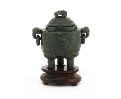 A Chinese jade incense burner,late Qing dynasty, the rounded sides carved with peony branches in relief, on three tall cylind