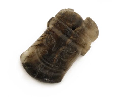 A Chinese jade pendant,Song dynasty (960-1279), in the shape of an axe, with a chilong seated above a taotie mask,6.6cm high宋