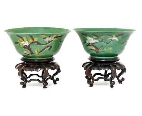 A pair of Chinese sancai bowls,Kangxi (1662-1722), each of rounded form with a flared rim, painted with blossoming branches i