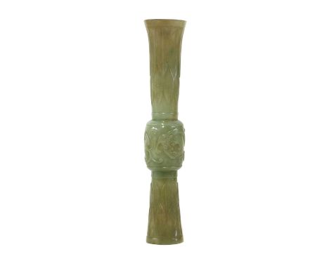 A Chinese jade vase,Ming dynasty (1368-1644), of gu form, the mid-section carved with two chilong in relief, the tall foot an