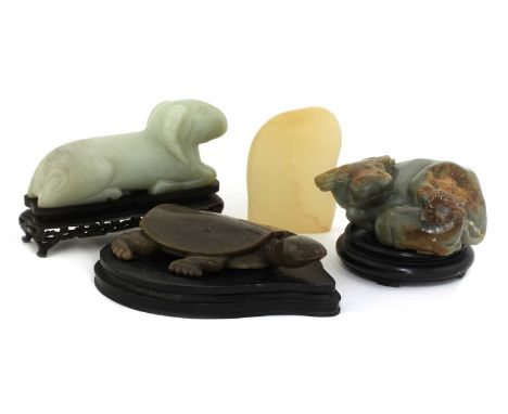 A collection of Chinese jade carvings, 20th century, comprising: a recumbent buffalo with a calf to the side, their heads tur