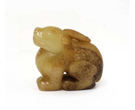 A Chinese jade carving, of a seated mythical beast, the stone of celadon tone with russet inclusions, 5cm longCondition repor