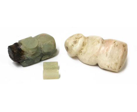 A Chinese jade carving, of a recumbent buffalo, 6.5cm long, an archaic hardstone figure, with apertures to the back, 9cm high