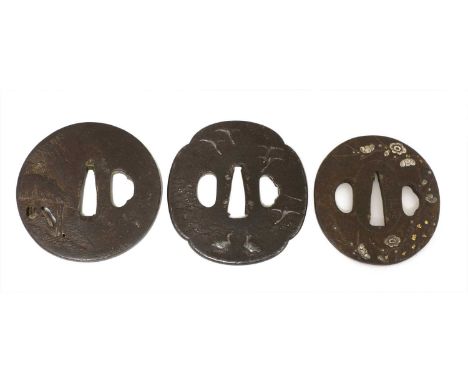 Three Japanese bronze tsuba,Meiji period (1868-1912), of typical form, comprising:one decorated with an ox coming out from a 